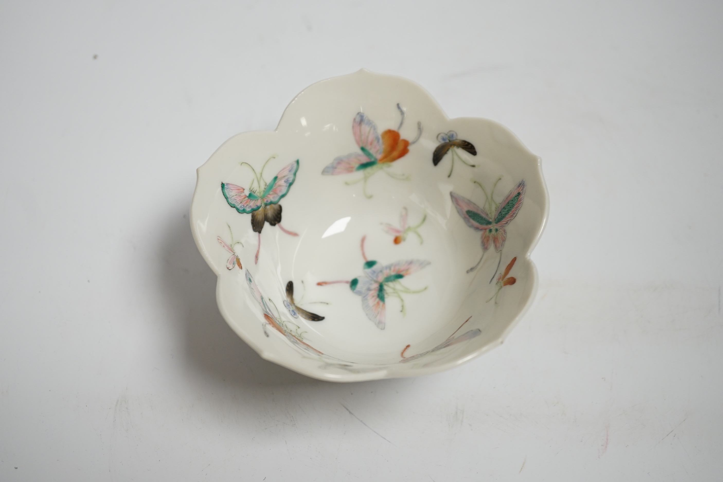 A Chinese porcelain tea bowl decorated with butterflies, probably early 19th century, 11.5cm diameter